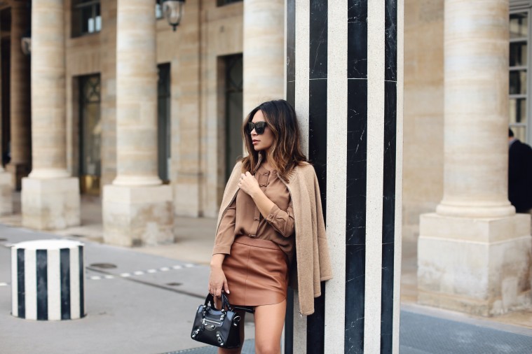marianna hewitt outfit paris fashion week tan leather skirt balenciaga bag tan cape